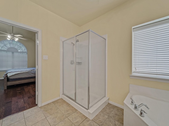 8431 Firewheel Ln, Frisco, TX 75036 - ensuite bathroom featuring a stall shower, ceiling fan, tile patterned floors, and baseboards