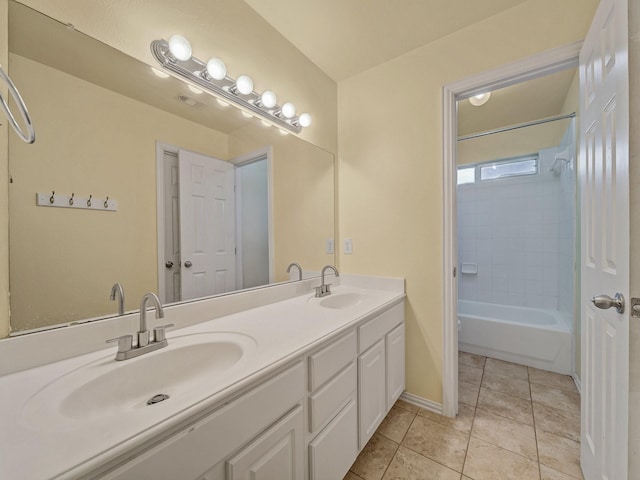 8431 Firewheel Ln, Frisco, TX 75036 - bathroom featuring tile patterned flooring, double vanity, baseboards, and shower / washtub combination