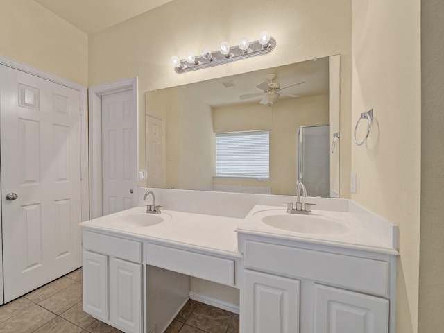 8431 Firewheel Ln, Frisco, TX 75036 - bathroom with a ceiling fan, double vanity, a shower stall, and tile patterned floors