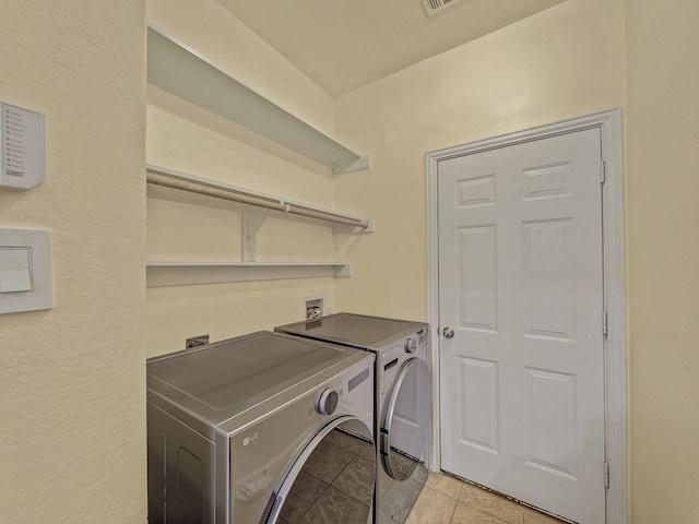 8431 Firewheel Ln, Frisco, TX 75036 - laundry area featuring washing machine and clothes dryer and light tile patterned flooring