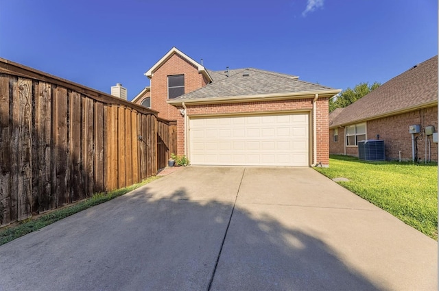 8431 Firewheel Ln, Frisco, TX 75036 - view of front of property with brick siding, central air condition unit, a shingled roof, and concrete driveway