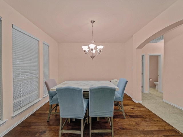 8431 Firewheel Ln, Frisco, TX 75036 - dining area with arched walkways, a chandelier, and baseboards