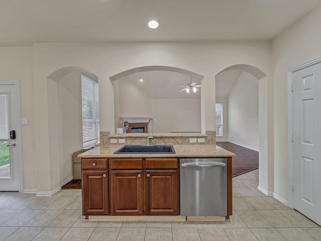 8431 Firewheel Ln, Frisco, TX 75036 - kitchen featuring stainless steel dishwasher, a sink, open floor plan, ceiling fan, and light tile patterned floors