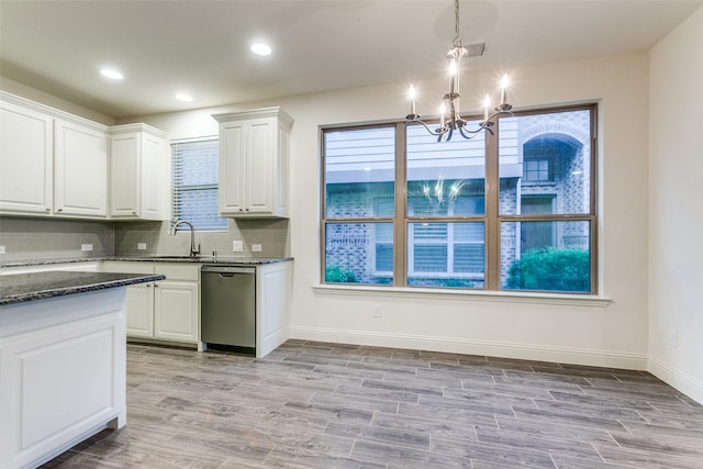 kitchen featuring stainless steel dishwasher, a chandelier, white cabinets, light wood-style floors, and backsplash