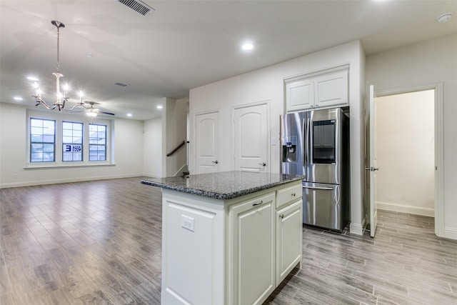 kitchen featuring stainless steel fridge with ice dispenser, a chandelier, a kitchen island, light wood-style flooring, and recessed lighting