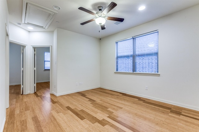 empty room with attic access, plenty of natural light, light wood-style flooring, ceiling fan, and recessed lighting