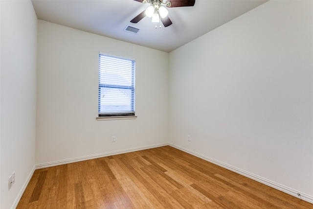 spare room featuring light wood-style flooring, baseboards, and a ceiling fan