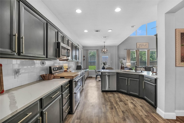 2812 Arabian Ln, Celina, TX 75009 - kitchen with stainless steel appliances, a sink, dark wood-type flooring, tasteful backsplash, and recessed lighting