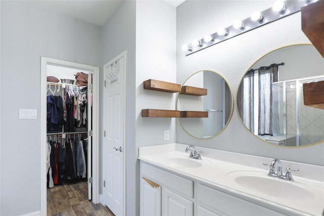 2812 Arabian Ln, Celina, TX 75009 - full bath featuring double vanity, a stall shower, wood finished floors, and a walk in closet