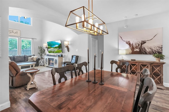 2812 Arabian Ln, Celina, TX 75009 - dining space with wood finished floors, a glass covered fireplace, and baseboards