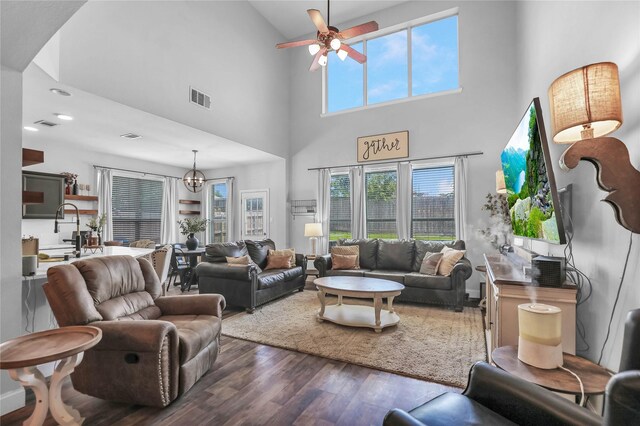 2812 Arabian Ln, Celina, TX 75009 - living room featuring wood finished floors, a towering ceiling, ceiling fan, and a chandelier