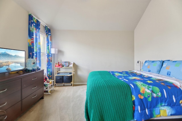 carpeted bedroom with lofted ceiling and baseboards