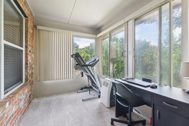 office space with brick wall and carpet floors