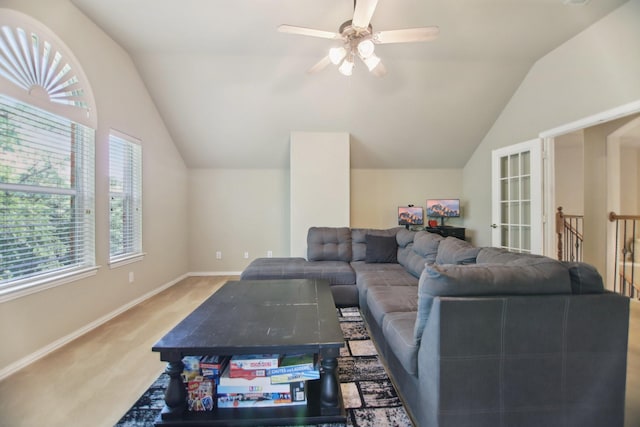 carpeted living area featuring lofted ceiling, a ceiling fan, and baseboards