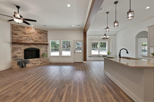 164 Vz County Road 2433, Canton, TX 75103 - unfurnished living room with a fireplace, a sink, dark wood-type flooring, a ceiling fan, and ornamental molding