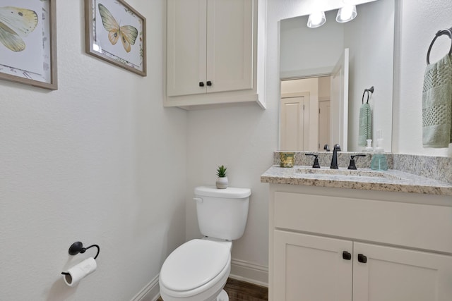 164 Vz County Road 2433, Canton, TX 75103 - half bathroom with baseboards, toilet, vanity, and wood finished floors