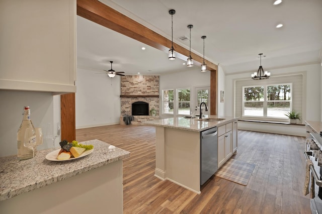 164 Vz County Road 2433, Canton, TX 75103 - kitchen with stainless steel dishwasher, a sink, a brick fireplace, recessed lighting, and wood finished floors