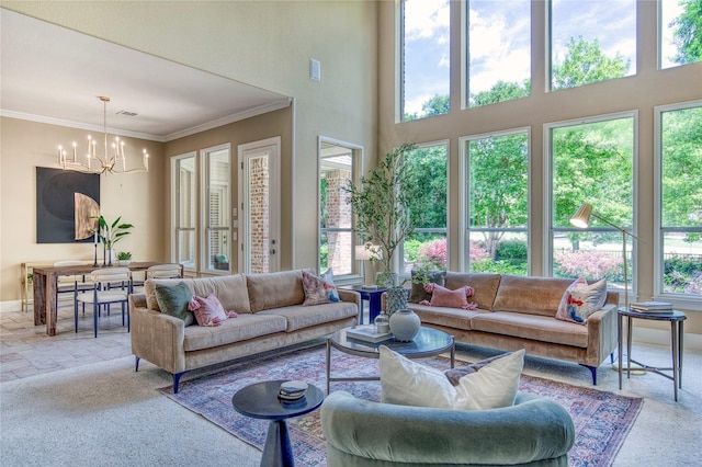 1900 Pembroke Ln, Mckinney, TX 75072 - carpeted living room featuring a chandelier, healthy amount of natural light, baseboards, crown molding, and a towering ceiling
