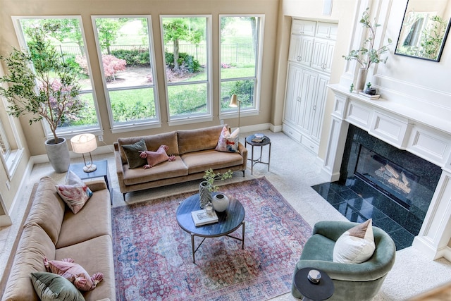 1900 Pembroke Ln, Mckinney, TX 75072 - living area featuring healthy amount of natural light, baseboards, and a premium fireplace