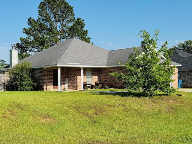 10159 English Oaks Dr, Keithville, LA 71047 - view of front of home with a front lawn, brick siding, a chimney, and roof with shingles
