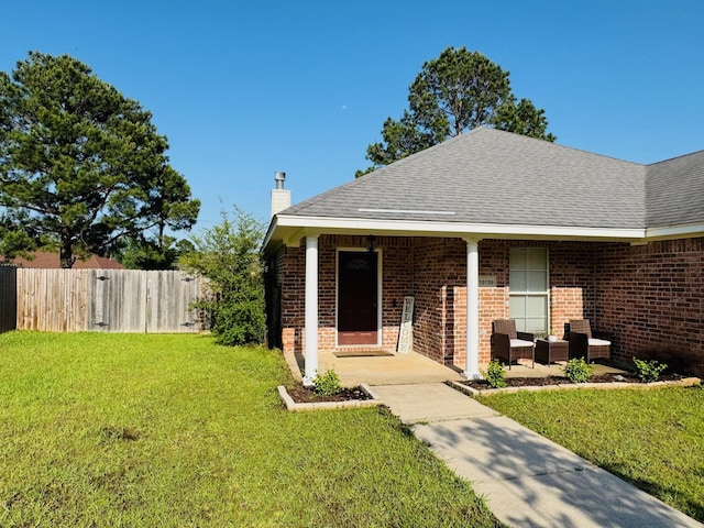 10159 English Oaks Dr, Keithville, LA 71047 - view of front facade with a chimney, brick siding, a shingled roof, and an outdoor living space