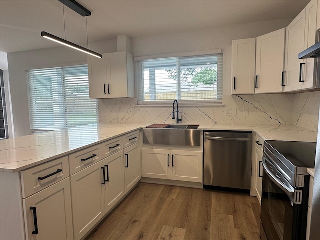 7501 Echo Hill Dr, Watauga, TX 76148 - kitchen with stainless steel dishwasher, a sink, electric range, a peninsula, and white cabinets