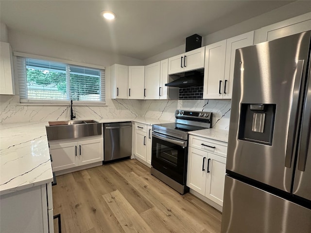 7501 Echo Hill Dr, Watauga, TX 76148 - kitchen featuring appliances with stainless steel finishes, under cabinet range hood, a sink, and white cabinetry