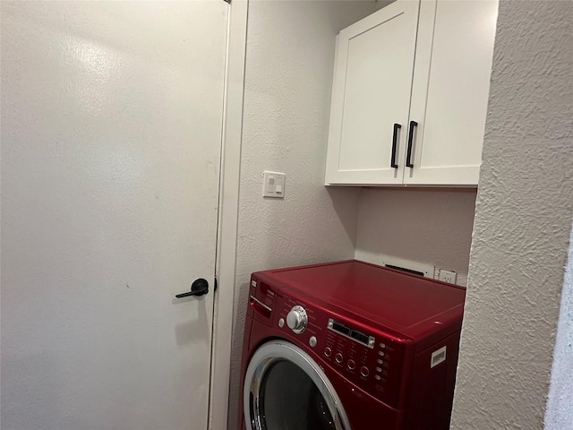 7501 Echo Hill Dr, Watauga, TX 76148 - laundry area with washer / clothes dryer, cabinet space, and a textured wall