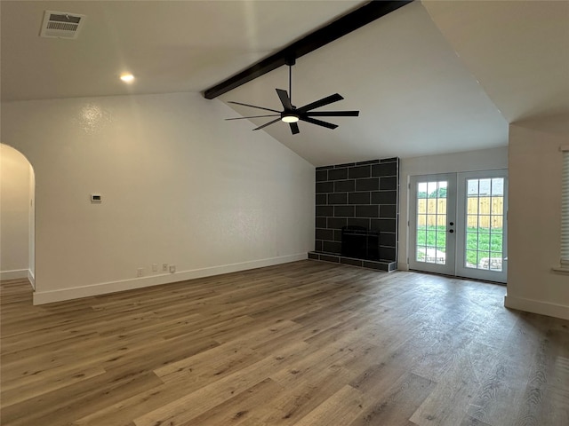 7501 Echo Hill Dr, Watauga, TX 76148 - unfurnished living room with ceiling fan, arched walkways, baseboards, and wood finished floors