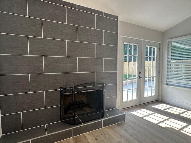 7501 Echo Hill Dr, Watauga, TX 76148 - detailed view of french doors, wood finished floors, and a tile fireplace