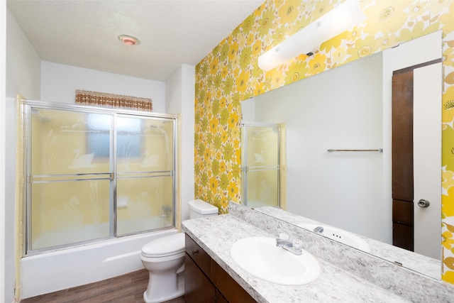 921 Meadow Mead Dr, Allen, TX 75002 - full bath featuring wallpapered walls, wood finished floors, toilet, vanity, and a textured ceiling
