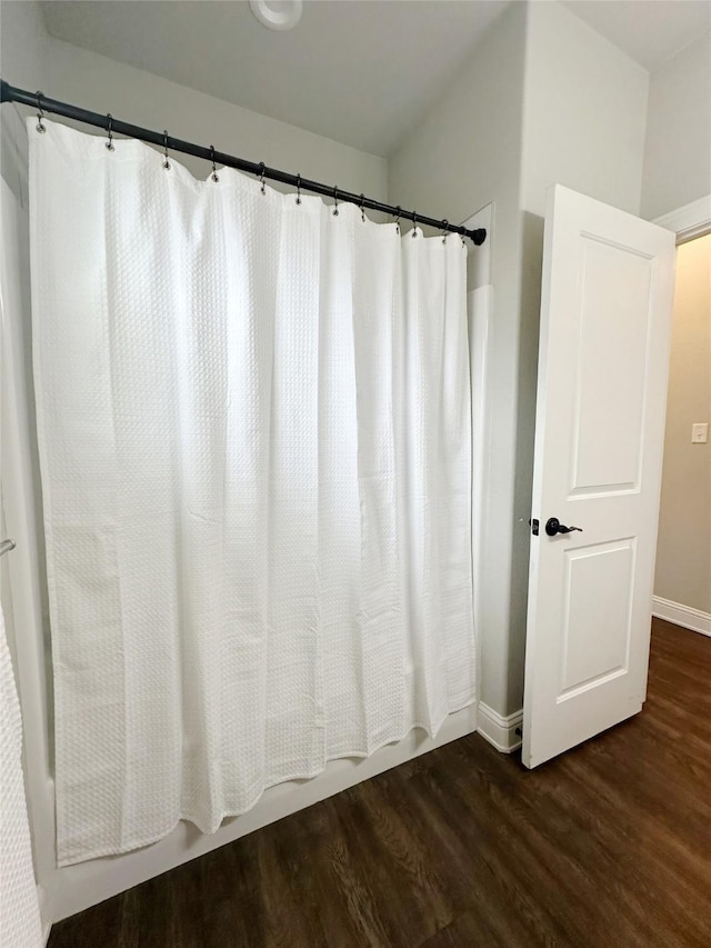 7415 Morning Glory Rd, Abilene, TX 79602 - full bath featuring wood finished floors, baseboards, and shower / bath combination with curtain