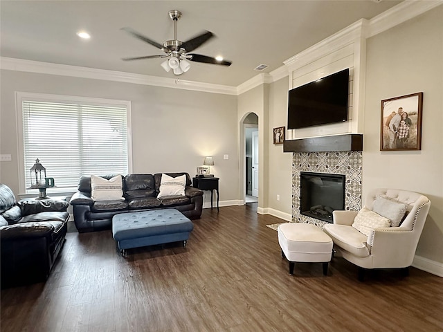 7415 Morning Glory Rd, Abilene, TX 79602 - living room featuring arched walkways, ceiling fan, dark wood-type flooring, crown molding, and baseboards