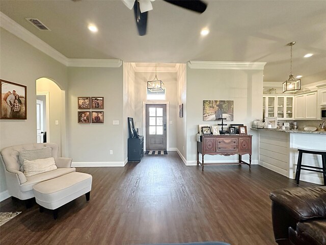 7415 Morning Glory Rd, Abilene, TX 79602 - foyer featuring a ceiling fan, crown molding, dark wood-type flooring, baseboards, and arched walkways