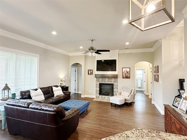 7415 Morning Glory Rd, Abilene, TX 79602 - living room featuring arched walkways, recessed lighting, baseboards, crown molding, and a tiled fireplace