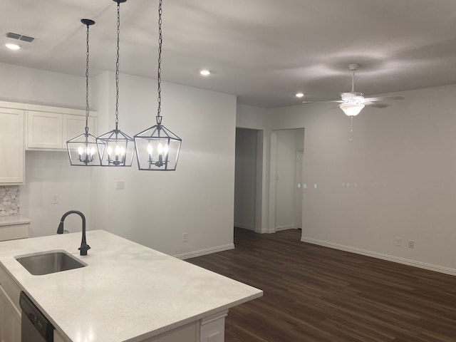 1613 Pine Valley Dr, Fort Worth, TX 76052 - kitchen with a sink, dishwasher, dark wood finished floors, baseboards, and white cabinetry