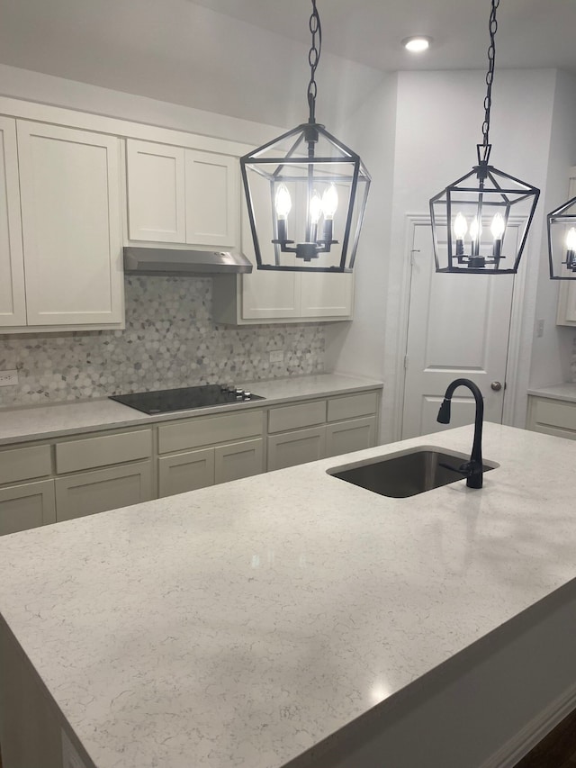1613 Pine Valley Dr, Fort Worth, TX 76052 - kitchen featuring a chandelier, a sink, black electric cooktop, and under cabinet range hood