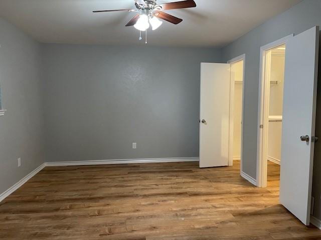 1942 S Lakeshore, Rockwall, TX 75087 - unfurnished bedroom with wood finished floors, baseboards, and a ceiling fan