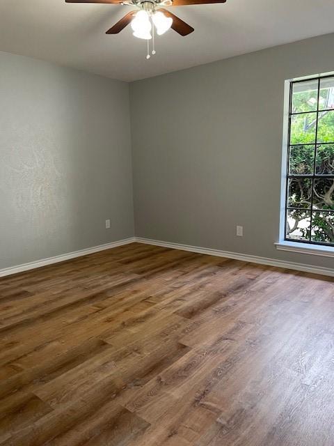 1942 S Lakeshore, Rockwall, TX 75087 - empty room featuring ceiling fan, wood finished floors, and baseboards