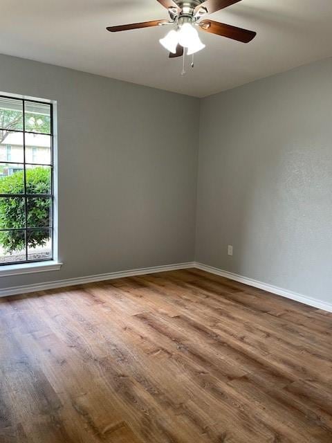 1942 S Lakeshore, Rockwall, TX 75087 - empty room featuring dark wood-type flooring, baseboards, and ceiling fan