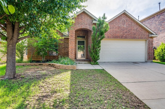 traditional-style house featuring brick siding, an attached garage, and concrete driveway