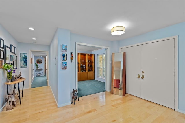 entryway with light wood-style floors, recessed lighting, and baseboards