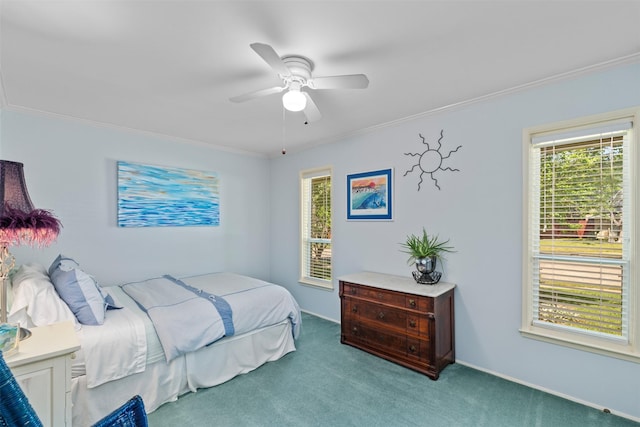 carpeted bedroom featuring crown molding and a ceiling fan