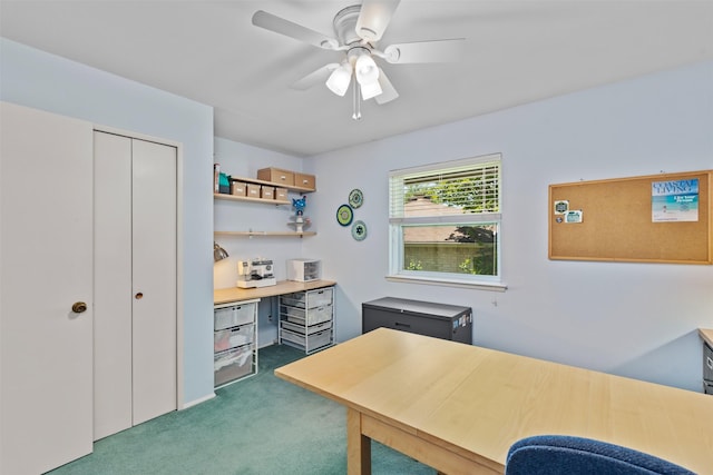 carpeted home office featuring ceiling fan