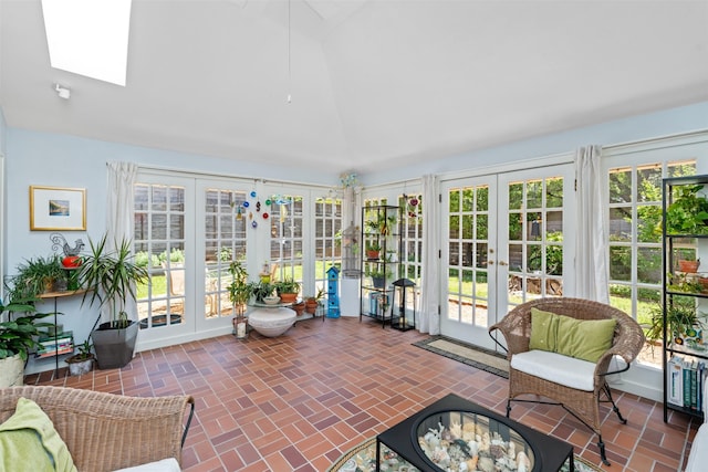 sunroom with french doors, vaulted ceiling, and a skylight