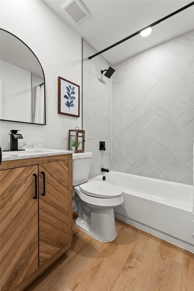 1303 Johns Dr, Euless, TX 76039 - bathroom with shower / bathtub combination with curtain, toilet, vanity, and wood finished floors