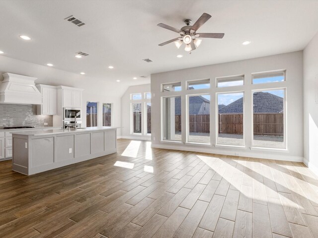 1423 Daisy Corner Dr, Celina, TX 75078 - unfurnished living room featuring wood finished floors, recessed lighting, baseboards, a ceiling fan, and lofted ceiling