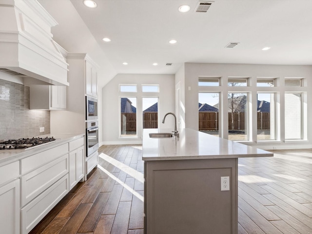 1423 Daisy Corner Dr, Celina, TX 75078 - kitchen with stainless steel appliances, premium range hood, dark wood-style floors, a sink, and recessed lighting