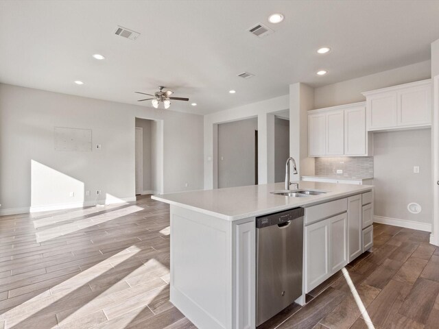 1423 Daisy Corner Dr, Celina, TX 75078 - kitchen with stainless steel dishwasher, a sink, wood tiled floors, recessed lighting, and white cabinetry