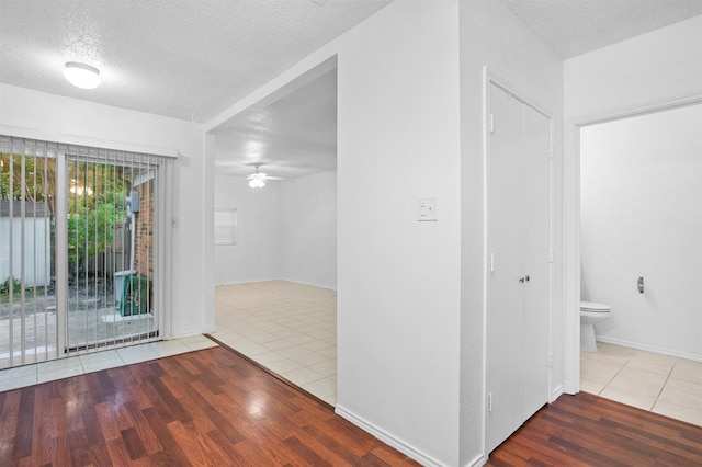 736 Lee St, Mesquite, TX 75149 - empty room featuring tile patterned floors, a textured ceiling, a ceiling fan, and baseboards